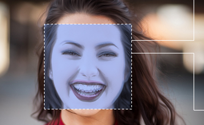 An image of a person smiling. Their face is framed by a bounding box.